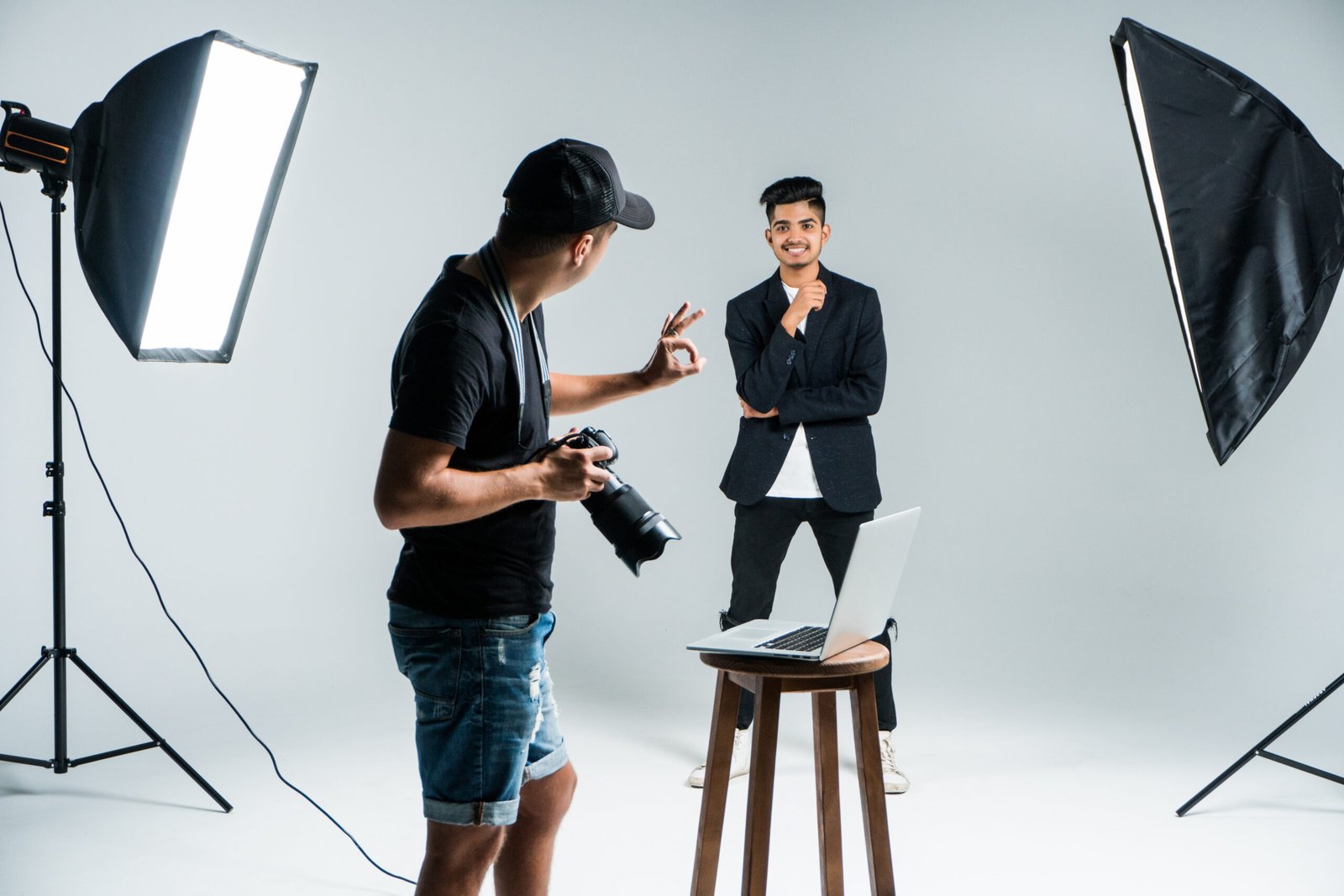 Professional photographer taking photos of indian model in studio with leight
